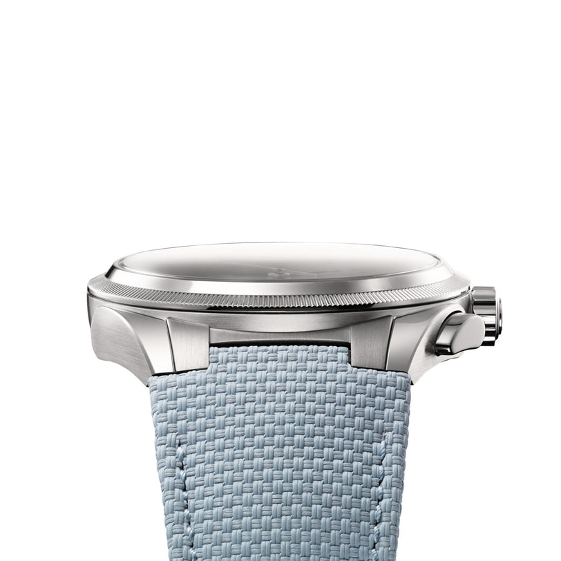 Side view of the Parmigiani Fleurier TONDA PF Sport Chronograph, a silver wristwatch with a textured light blue strap, displayed against a white background.