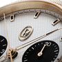 Close-up of the Parmigiani Fleurier TONDA PF Sport Chronograph watch face, featuring gold accents, a textured dial, and two black subdials.