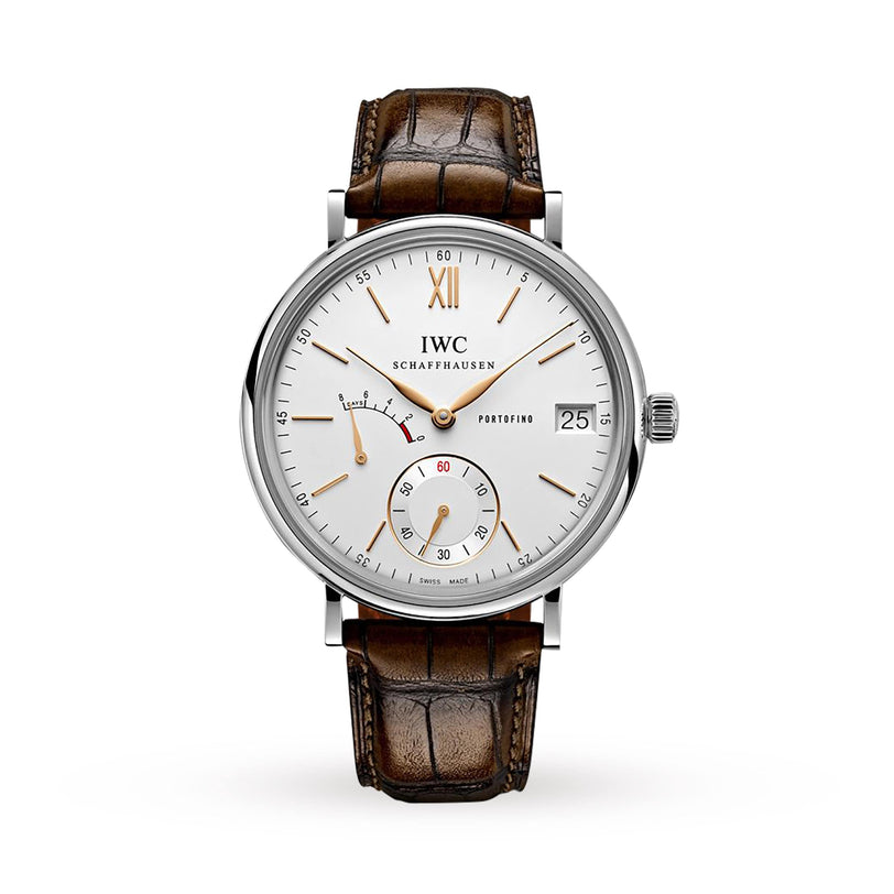 The IWC Schaffhausen Portofino Hand-Wound Eight Days features a white dial, brown leather strap, gold hour markers, date at 3 o’clock, and two subdials for seconds and power reserve with an in-house calibre.