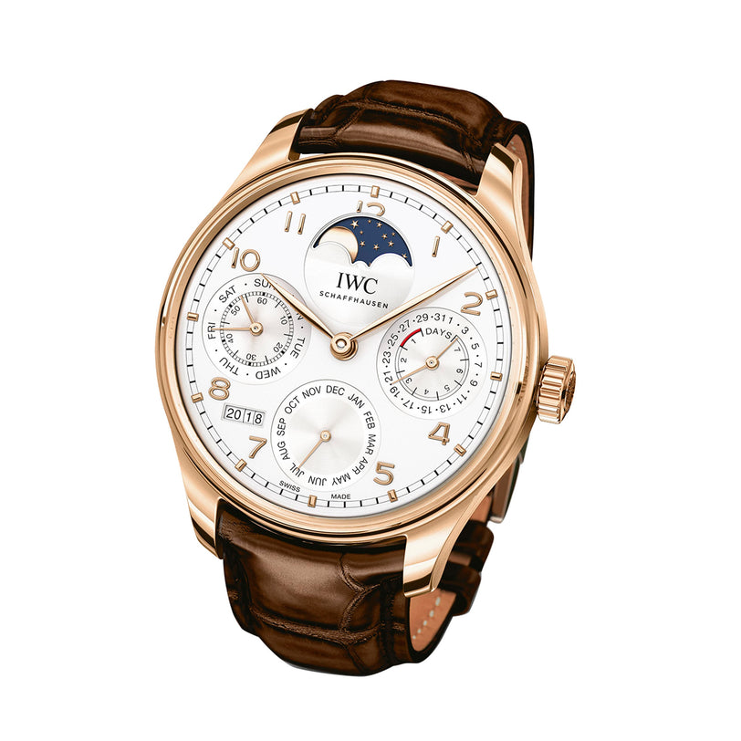 The IWC Schaffhausen Portugieser Perpetual Calendar is a luxury wristwatch with an 18ct gold case, brown leather strap, white dial, moon phase display, and a perpetual calendar showing date, day, month, and year on multiple subdials.