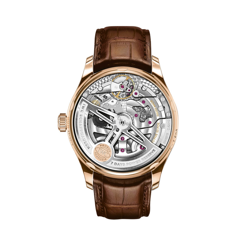 The IWC Schaffhausen Portugieser Automatic features a brown leather strap, an 18ct 5N gold case, and an exhibition case back displaying its mechanical movement.