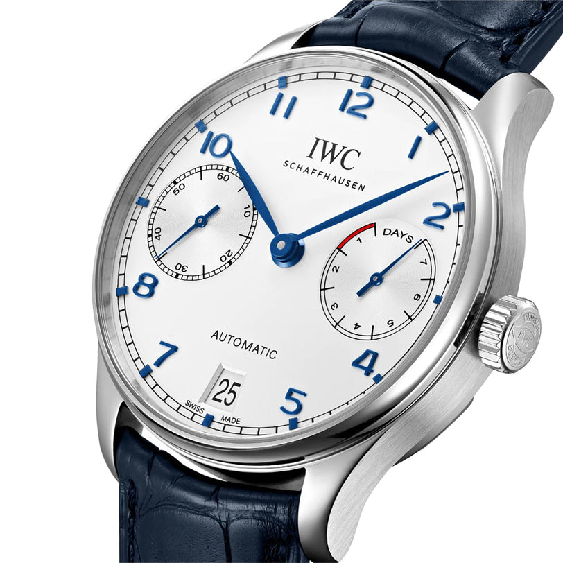 A close-up of the IWC Schaffhausen Portugieser Automatic wristwatch with a white dial, blue numerals, seconds and days subdials, date window, and blue leather strap—showcasing engineering excellence.
