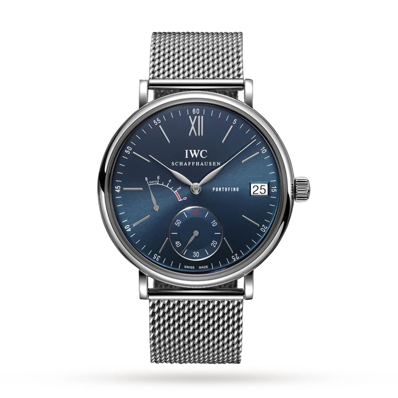 The IWC Schaffhausen Portofino Hand-Wound Eight Days wristwatch features a silver case, blue dial, date display, mesh bracelet, and subdials with a manual-winding movement, shown against a white background.