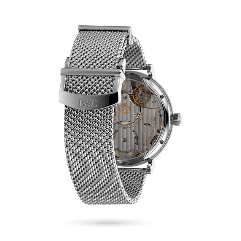 The IWC Schaffhausen Portofino Hand-Wound Eight Days features a silver mesh band, blue dial, and a transparent case back that reveals its detailed manual-winding movement.