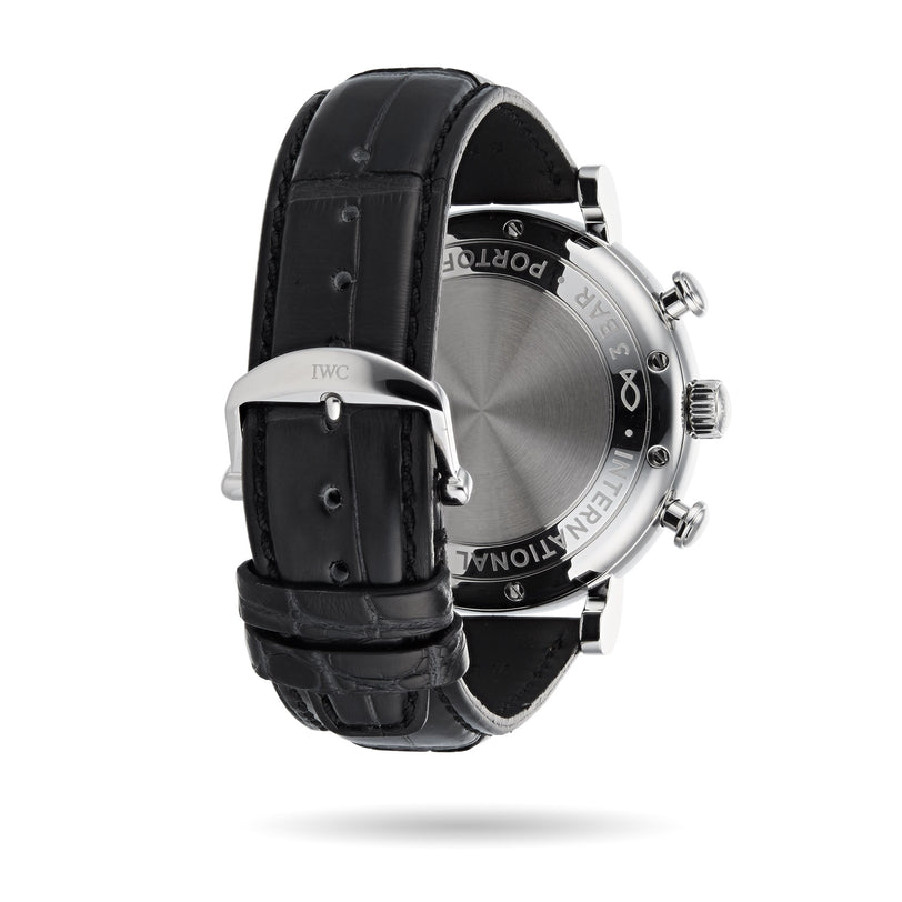 A close-up of the back of the IWC Schaffhausen Portofino Chronograph, showing detailed engravings on the case and a black leather strap with a metal clasp engraved with IWC.