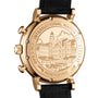 Close-up of the IWC Schaffhausen Portofino Chronographs 18ct 5N gold case back, engraved with a building scene and labeled INTERNATIONAL WATCH CO. PORTOFINO 3 BAR, on a black leather strap with automatic self-winding movement.