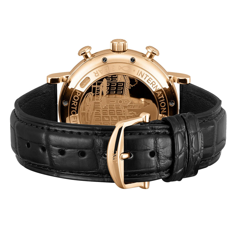 The IWC Schaffhausen Portofino Chronograph features an 18ct 5N gold case and black leather strap, displayed from the back to reveal its engraved case and buckle.