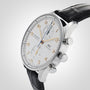An IWC Schaffhausen Portugieser Chronograph wristwatch with a white dial, gold numerals, black leather strap, and stainless steel case is shown at an angle on a light background.
