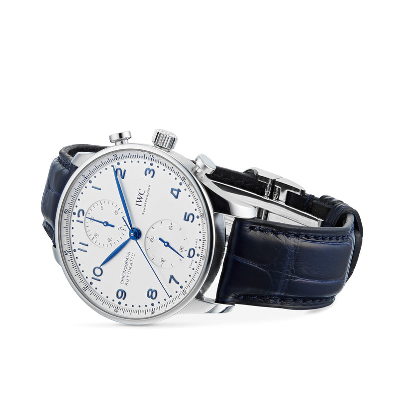 The IWC Schaffhausen Portugieser Chronograph features a stainless steel case, white dial with blue markers, and a dark blue leather strap—showcasing timeless elegance on a white background.