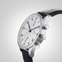 An IWC Schaffhausen Portugieser Chronograph wristwatch with a stainless steel case, white dial, blue hands and numerals, two subdials, and a black leather strap, displayed at an angle on a light grey background.