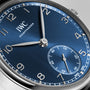Close-up of the IWC Schaffhausen Portugieser Automatic 40 wristwatch, showcasing a blue dial, silver hour markers, small seconds at 6 o’clock, and an IWC-manufactured 82200 calibre with Pellaton winding.