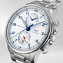 The IWC Schaffhausen Portugieser Yacht Club Chronograph features blue numerals and hands, two subdials, a date window at 3 o’clock, and a metal bracelet—showcasing refined nautical sports watch style on a light background.