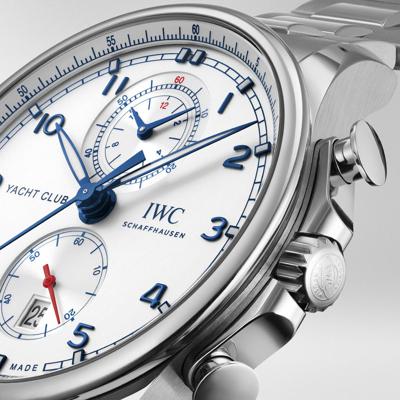 Close-up of the IWC Schaffhausen Portugieser Yacht Club Chronograph, a nautical sports watch featuring a white dial, blue hands and numerals, subdials, date display, and a stainless steel case with matching bracelet.