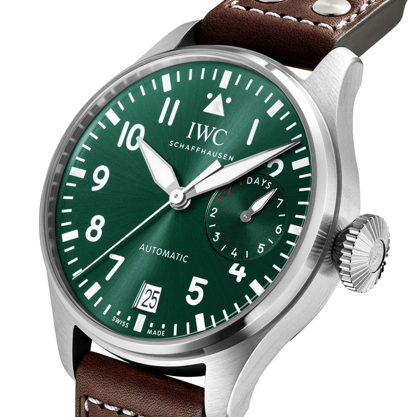 A close-up of an IWC Schaffhausen Big Pilots Watch featuring a green dial with white numerals, date display, 7-day power reserve indicator, and a brown leather strap.