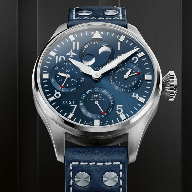 Close-up of the IWC Schaffhausen Big Pilot’s Watch Perpetual Calendar with blue dial, multiple subdials for date, day, month, year, moon phase, a blue leather strap with white stitching, and an IWC-manufactured 52615 calibre.