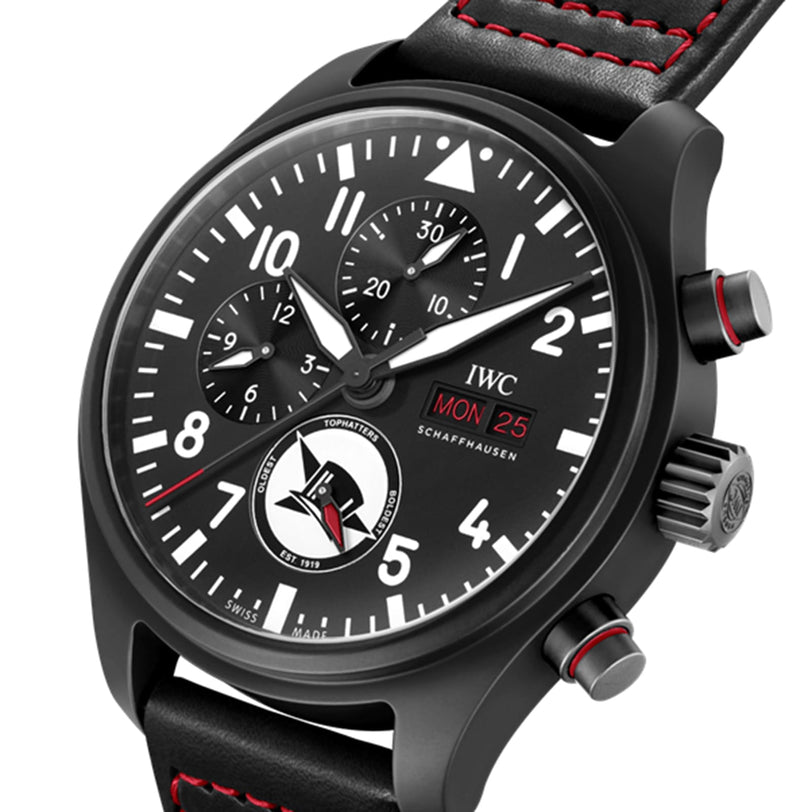 The IWC Schaffhausen Pilots Watch Chronograph Edition Tophatters features a black ceramic case, red accents, three subdials, black leather strap with red stitching, and a day-date display set to Monday the 25th.