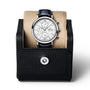 The IWC Schaffhausen Portofino Chronograph, featuring a white dial, stainless steel case, and black leather strap, is displayed on a beige cushion inside a black leather watch case.