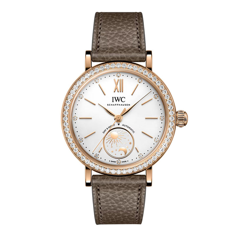 The IWC Schaffhausen Portofino Automatic Day & Night 34 is a luxury wristwatch featuring a brown leather strap, diamond bezel, and white dial with moon phase display.