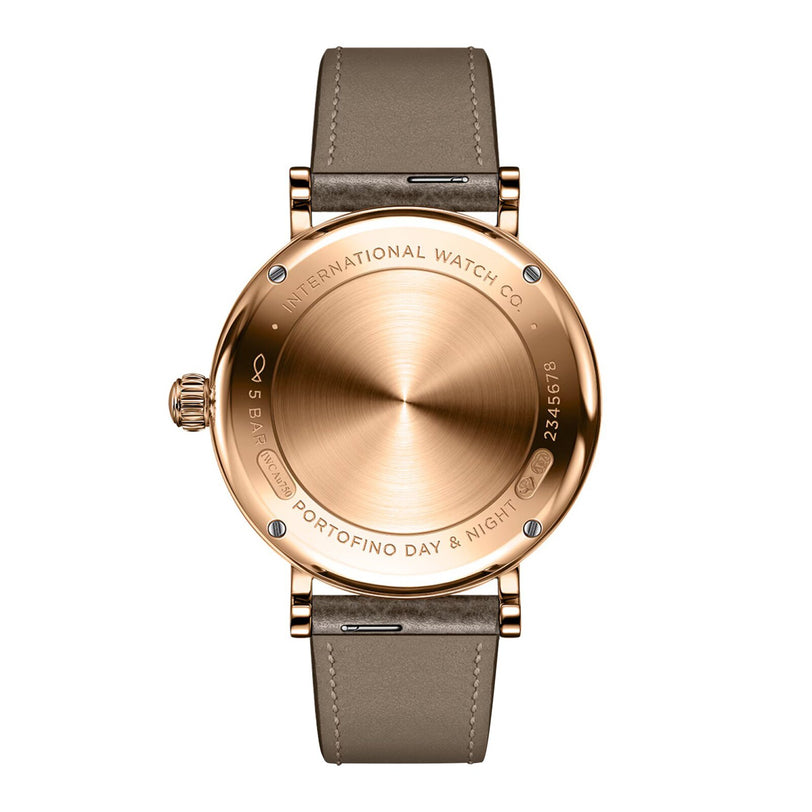Back view of the IWC Schaffhausen Portofino Automatic Day & Night 34 gold wristwatch featuring a brown leather strap and engraved text around the case.