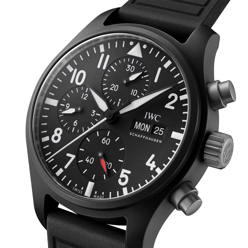 Black chronograph watch with dark dial, multiple subdials, white numerals and hands, red accent, and black rubber strap.