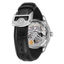 The image shows the back of the IWC Schaffhausen Portugieser Automatic 42, featuring a black leather strap and stainless steel case with a transparent back that reveals its mechanical movement and fine details.