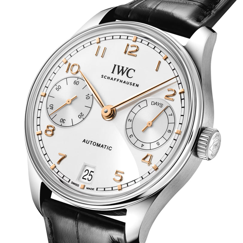 The IWC Schaffhausen Portugieser Automatic 42 features a silver case, white dial with gold numerals, black leather strap, and displays the time and date.