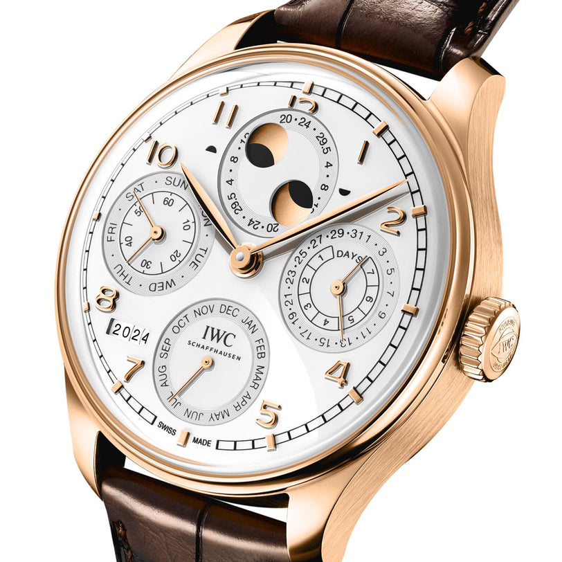The IWC Schaffhausen Portugieser Perpetual Calendar 44 is a rose gold wristwatch with a white dial, brown leather strap, and displays for date, month, day subdials, plus a moon phase perpetual calendar.