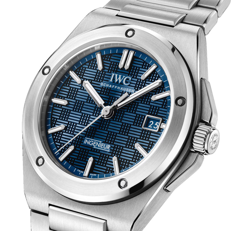 The IWC Schaffhausen Ingenieur Automatic 40 features a silver case, blue textured dial, silver hour markers, and a date window at 3 o’clock.