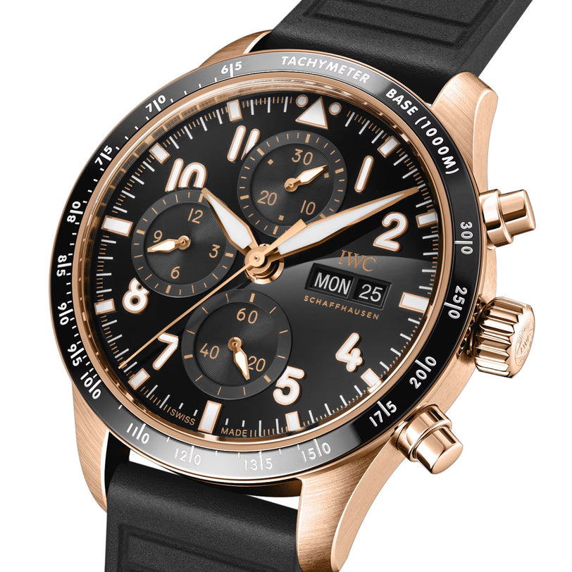 The IWC Schaffhausen Pilots Watch Performance Chronograph 41 features an 18-carat gold case, black dial with three subdials, day and date display, tachymeter bezel, and a black rubber strap.