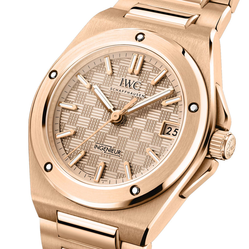 The IWC Schaffhausen Ingenieur Automatic 35 features a textured dial, date display at 3 o’clock, and a matching gold metal bracelet.