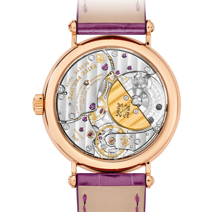 Close-up of Patek Philippe Calatrava 7200/200R-001’s exposed mechanical movement, featuring gold, silver, and purple details on a leather strap.