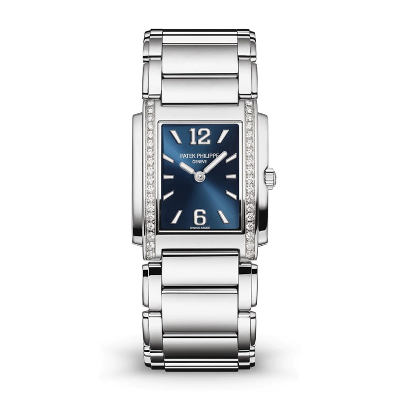 The Patek Philippe Twenty~4 4910/1200A-001 is a silver watch featuring a blue rectangular face and diamond-accented case.