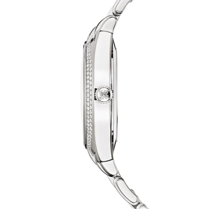 Side view of Patek Philippe’s Twenty~4 7300/1200A-011, a slim silver wristwatch featuring a diamond-studded bezel and a detailed crown.