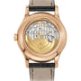 Close-up of the back of a Patek Philippe Complication 5205R-011 watch, showcasing its intricate mechanical movement.