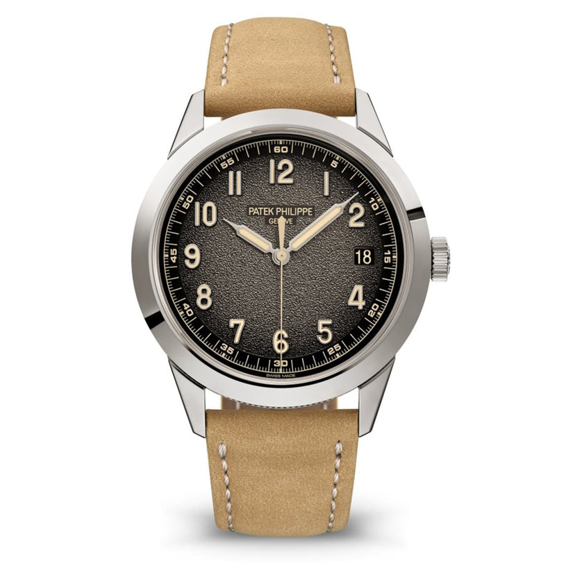 The Patek Philippe Calatrava 5226G-001 wristwatch features a textured black dial and a tan leather strap.