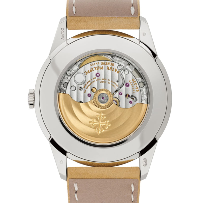 Close-up of the Patek Philippe Calatrava 5226G-001’s transparent case back, revealing intricate gears and a gold rotor engraved with the emblem.