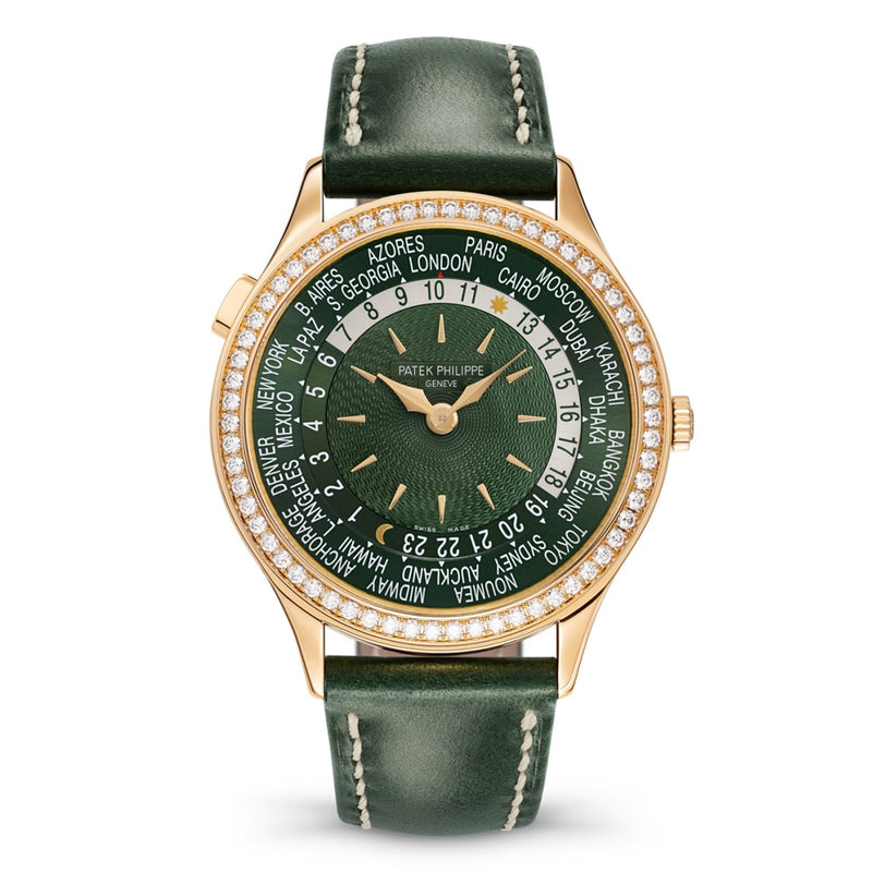 A Patek Philippe Complication 7130R-014 wristwatch featuring world time cities around the dial, in green and gold tones.