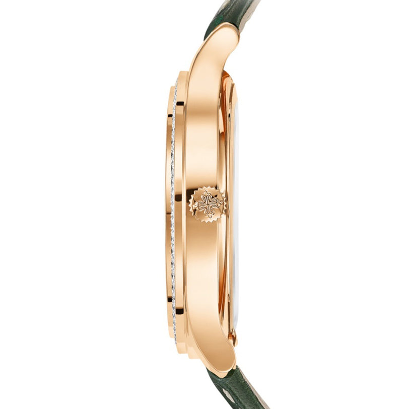 Side view of the Patek Philippe Complication 7130R-014, featuring a gold case, a green strap, and an engraved crown on the watch’s edge.