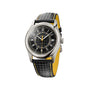 The Patek Philippe Calatrava 6007G-001 is a luxury watch featuring a black textured dial, matching black strap with yellow accents, and a silver case.