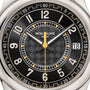 Close-up of a Patek Philippe Calatrava 6007G-001 watch face in black, featuring geometric patterns and yellow accents, displaying the time 1:58:00.