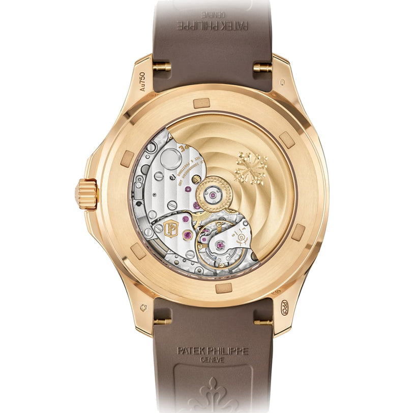 Close-up of a Patek Philippe Aquanaut 5268/200R-010 watch back, revealing its exposed mechanical movement, gold case, and brown strap.