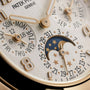 Close-up of the Patek Philippe Twenty~4 7340/1R-001 watch face displaying day, date, month, and moon phase indicators.