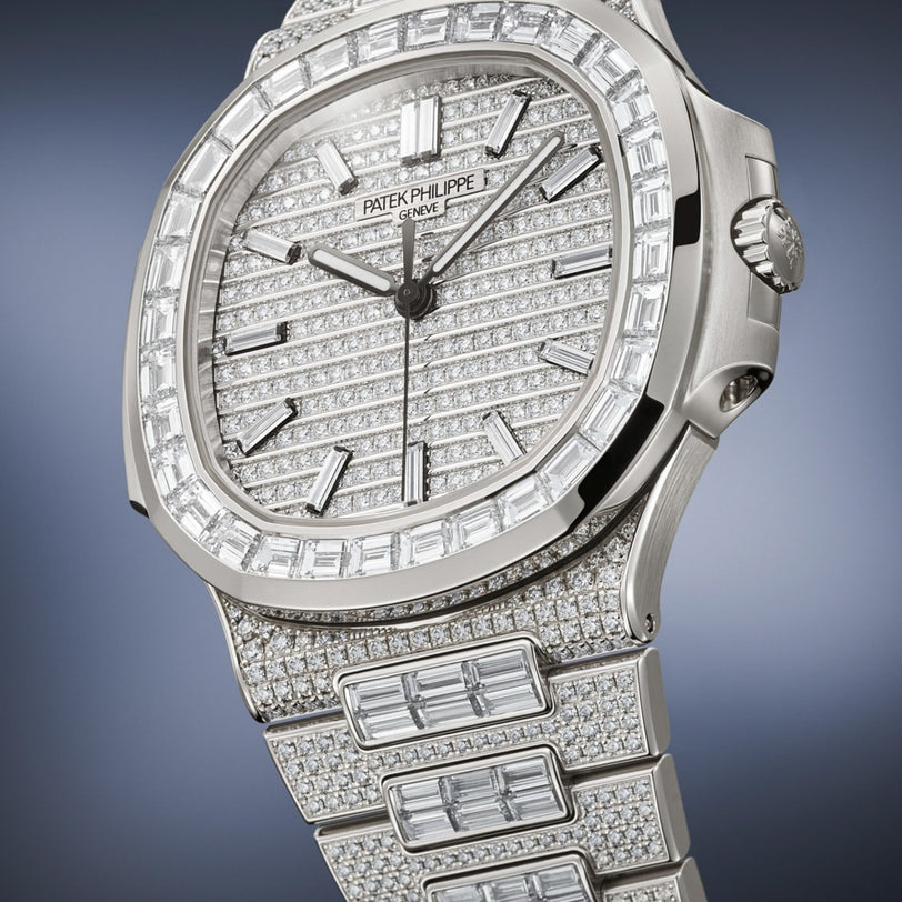 The Patek Philippe Nautilus 5811/1460G-001, a luxury watch, features diamonds encrusted on the face, bezel, and bracelet, shown in a close-up view.