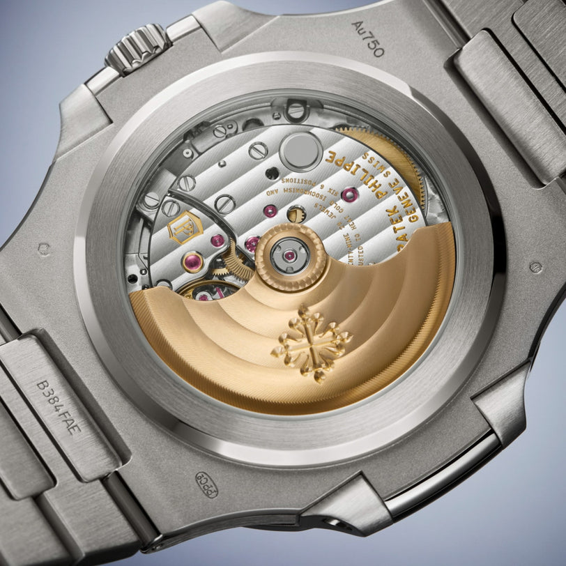 Close-up of the Patek Philippe Nautilus 5811/1460G-001’s open caseback revealing intricate gears and a gold-toned rotor.