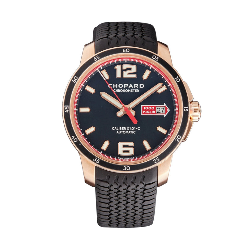The Chopard Mille Miglia GTS Automatic watch features a black dial, gold case, black rubber strap, red accents, and a date display at 3 o’clock—showcasing luxury design inspired by automotive engineering and Mille Miglia heritage.