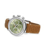 Chopard Mille Miglia Classic Chronograph with a green dial and brown perforated leather strap, displayed at an angle.