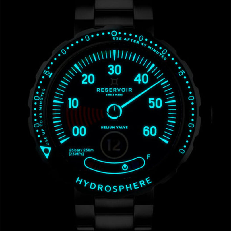 The Reservoir Hydrosphere Blue Hole watch features a glowing blue face that displays numbers, the “Hydrosphere” name, and diving indicators in the dark.