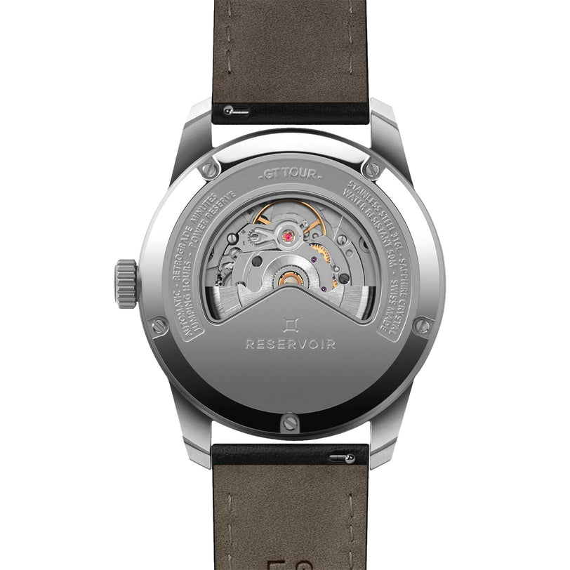 The Reservoir GT Tour displays its intricate inner movement through a transparent case back, showcasing the mechanics of this distinctive wristwatch.