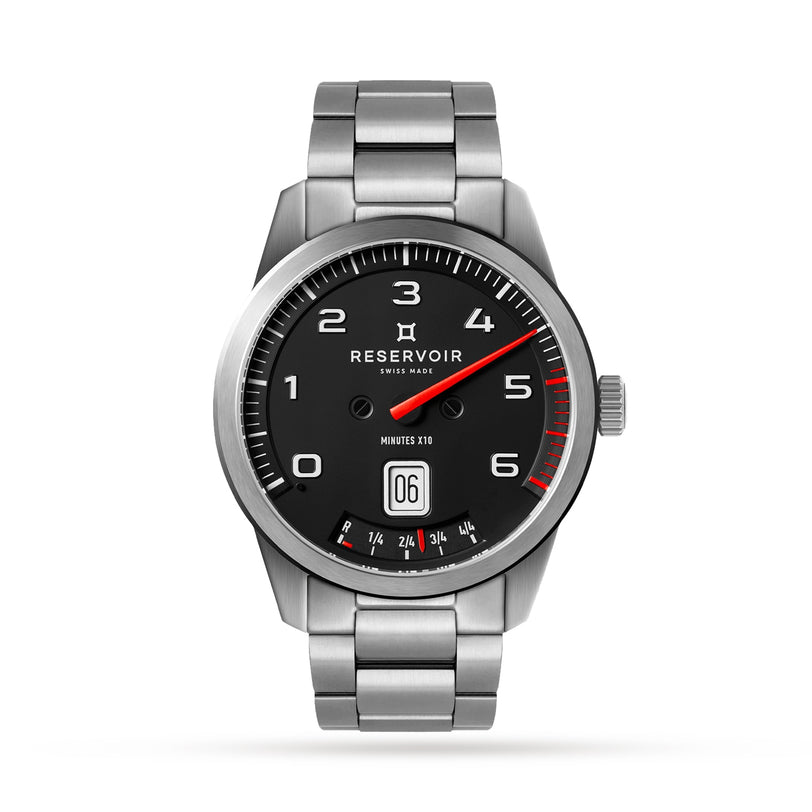 The Reservoir GT Tour is a silver wristwatch featuring a black dial with white numerals, red accents, and a metal link band.