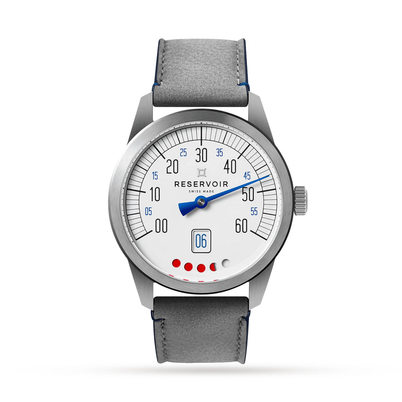 Part of the Reservoir Tiefenmesser collection, this wristwatch showcases a white dial with black and blue numerals, a single blue hand, a circular date window at 6 o’clock, grey leather strap, and five red dots inspired by submarine gear.